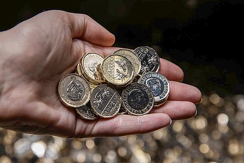 One-pound coins featuring King Charles, British bees